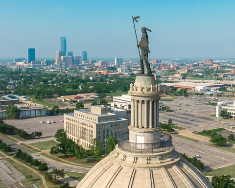 The Guardian statue atop the Oklahoma State Capitol dome, with the Oklahoma City skyline and Capitol complex beyond
